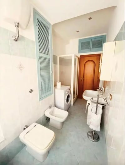 Toilet bidet washing machine sink bathroom at One-Bedroom Apartment in Rome in Rome Student Accommodation