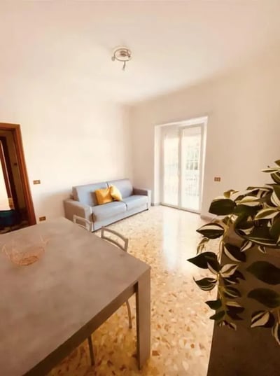 Sofa with cushions dining table chairs living room at One-Bedroom Apartment in Rome in Rome Student Accommodation