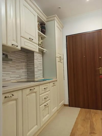 Cream cabinets countertop backsplash door kitchen at Nice Studio in Rome in Rome Student Accommodation