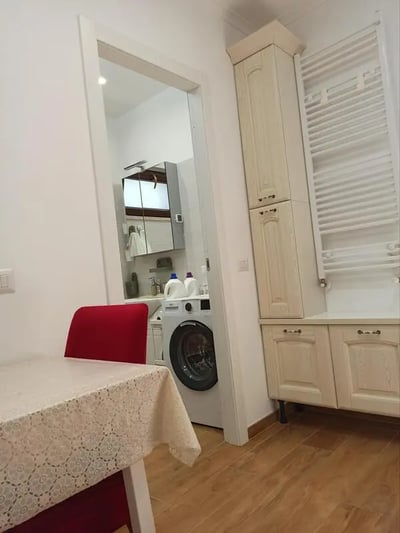 Table chair washing machine laundry area at Nice Studio in Rome in Rome Student Accommodation
