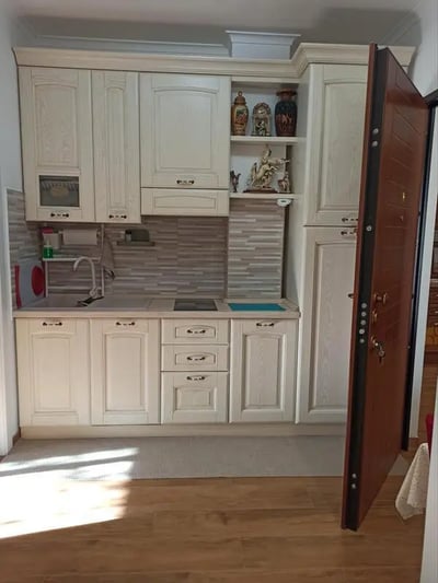 White cabinets sink stove and decorative objects kitchen at Nice Studio in Rome in Rome Student Accommodation