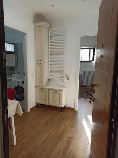 Cabinet radiator washing machine and table hallway at Nice Studio in Rome in Rome Student Accommodation