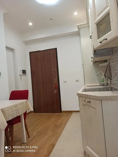 Dining table red chair wooden door kitchen area at Studio in Rome in Rome Student Accommodation