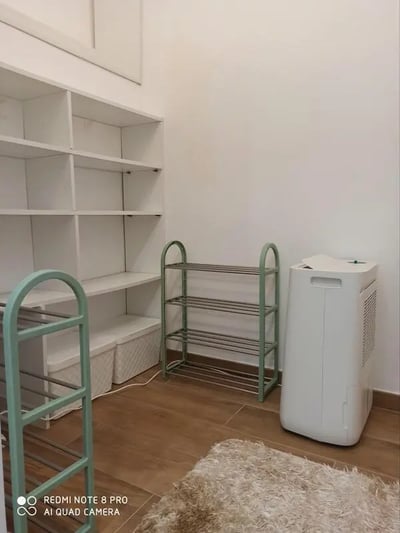 White shelves shoe racks air conditioner storage baskets room at Studio in Rome in Rome Student Accommodation