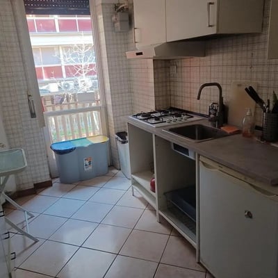 Compact kitchen with stove sink and fridge kitchen at Bedroom in shared apartment in Rome Student Accommodation