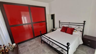 Red wardrobe white bed red pillows bedroom at Double bedroomLa Sapienza - Tor Vergata - RBS in Rome Student Accommodation