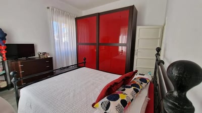 Red wardrobe, bed, dresser, and TV bedroom at Double bedroomLa Sapienza - Tor Vergata - RBS in Rome Student Accommodation
