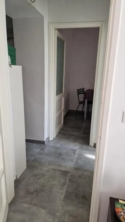 Hallway with doorway showing a dining table and chair kitchen at Sunny double room La Sapienza - Tor Vergata RBS in Rome Student Accommodation