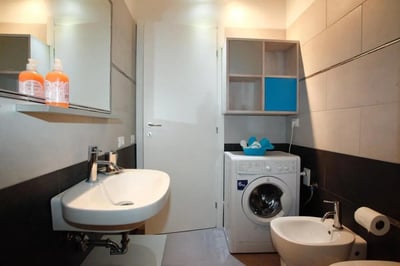 Sink washing machine bidet and toiletries bathroom at Chic Studio with Mezzanine in Parioli, Rome | Wi-Fi and Central Heating Included in Rome Student Accommodation