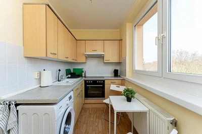 Cabinets sink washing machine stove table kitchen at Very cosy single bedroom in Stern in Potsdam Student Accommodation