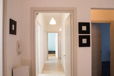 Hallway with doors artwork and light fixture hallway at Large single bedroom in Mompiano in Brescia Student Accommodation