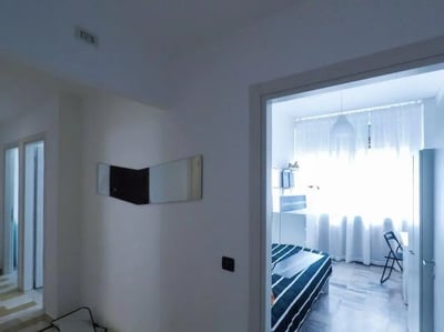 Bed with striped duvet and desk bedroom at Large single bedroom in Mompiano in Brescia Student Accommodation