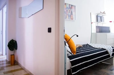 Striped bed orange pillow picture bedroom at Large single bedroom in Mompiano in Brescia Student Accommodation