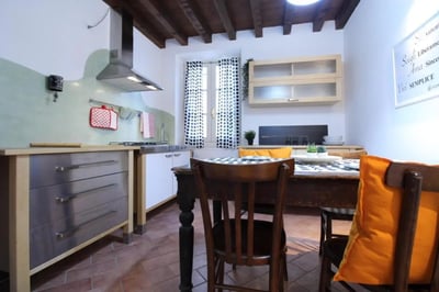 Kitchen with dining table and chairs kitchen. at Charming single bedroom near Università Cattolica del Sacro Cuore in Brescia Student Accommodation