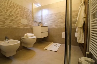 Toilet bidet sink towels bathrobe rack bathroom at Charming single bedroom near Università Cattolica del Sacro Cuore in Brescia Student Accommodation