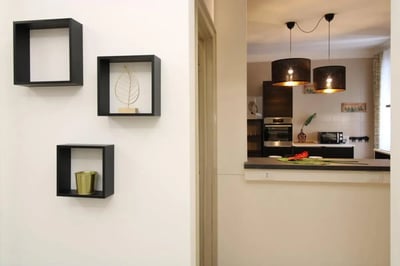 Shelves holding decor and vase kitchen area kitchen at Very cosy single bedroom near Parco dell'Acqua in Brescia Student Accommodation
