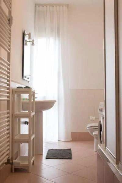 Sink shelf toilet washing machine bathroom at Snug single bedroom in Mompiano in Brescia Student Accommodation
