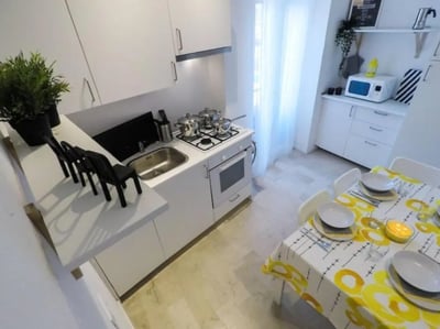 Compact kitchen with sink stove microwave dining table kitchen at Delightful single bedroom in Crocifissa di Rosa in Brescia Student Accommodation