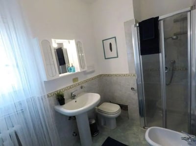 Sink toilet shower with towels framed art bathroom. at Delightful single bedroom in Crocifissa di Rosa in Brescia Student Accommodation