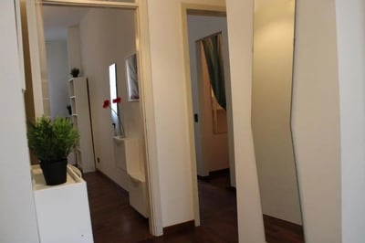 Hallway with plants and artwork hallway interior at Homely single bedroom near Facoltà di Medicina e Chirurgia in Brescia Student Accommodation