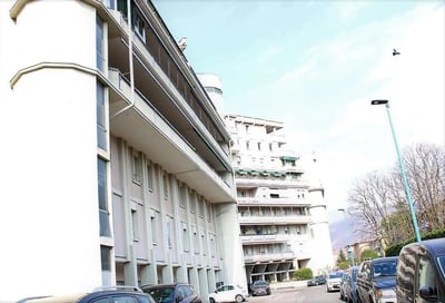 Apartment building with balconies and parked cars exterior at Homely single bedroom near Facoltà di Medicina e Chirurgia in Brescia Student Accommodation