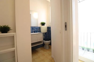 Sink toilet and blue tiled walls bathroom at Spacious single bedroom near the Brescia train station in Brescia Student Accommodation