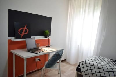 Desk laptop plant and chair study area at Pretty nice single bedroom in Borgo Trento in Brescia Student Accommodation