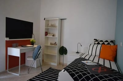 Desk chair bookshelf bed and TV bedroom at Pretty nice single bedroom in Borgo Trento in Brescia Student Accommodation