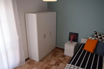 White wardrobe bedside table and bed bedroom at Pretty nice single bedroom in Borgo Trento in Brescia Student Accommodation