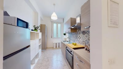 Fridge microwave oven sink cabinets patterned backsplash kitchen at Very nice single bedroom near Facoltà di Medicina e Chirurgia in Brescia Student Accommodation
