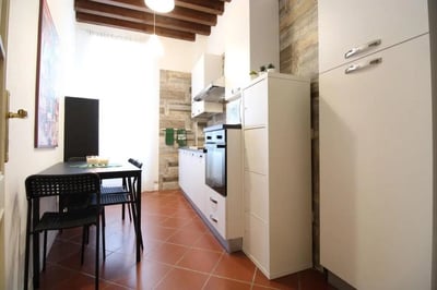 Dining table black chairs oven kitchen appliances kitchen at Brilliant single bedroom near Università Cattolica del Sacro Cuore in Brescia Student Accommodation