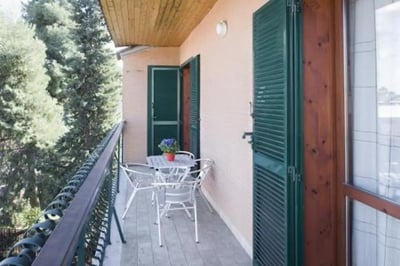 Table and chairs with potted plant balcony exterior at Fresh 1-bedroom apartment in the Ponte Galeria area in Rome Student Accommodation