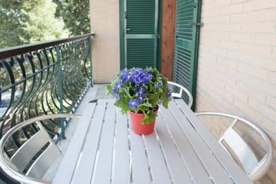 Table chairs potted plant balcony exterior at Fresh 1-bedroom apartment in the Ponte Galeria area in Rome Student Accommodation
