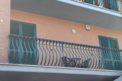 Balcony table chairs windows with shutters exterior at Fresh 1-bedroom apartment in the Ponte Galeria area in Rome Student Accommodation