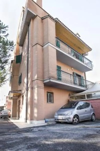 Apartment building with cars and balconies exterior at Fresh 1-bedroom apartment in the Ponte Galeria area in Rome Student Accommodation