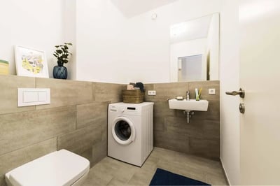 Toilet washing machine sink with mirror bathroom at Neat single bedroom in Europacity in Berlin Student Accommodation