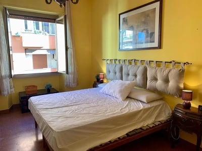 Bed with white linens and upholstered headboard bedroom at Large double bedroom close to the Trastevere train station in Rome Student Accommodation