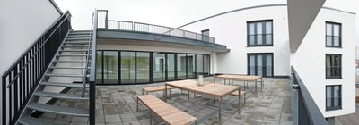 Outdoor seating area with tables and benches exterior at Inviting studio close to the Tübingen Derendingen train station in Tübingen Student Accommodation