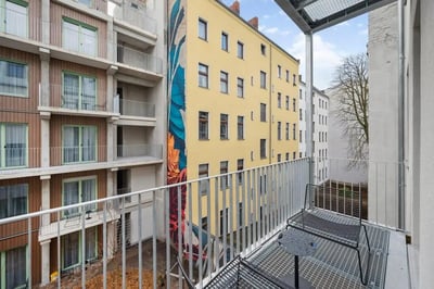 Balcony with chairs table and building exterior balcony at Cosy single bedroom near Beusselstraße train station in Berlin Student Accommodation