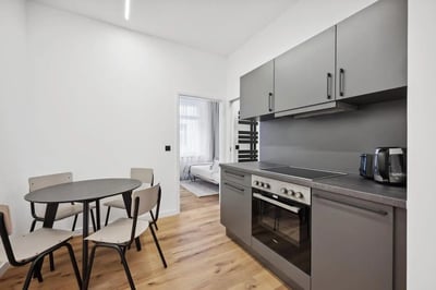 Round table four chairs modern kitchen cabinets kitchen. at Cosy single bedroom near Beusselstraße train station in Berlin Student Accommodation