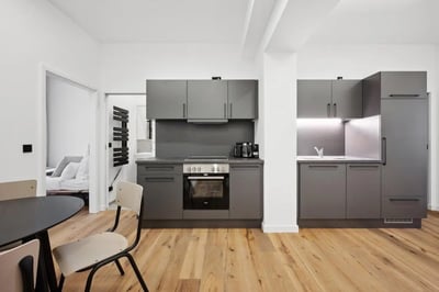Modern grey kitchen with oven and dining table kitchen at Cosy single bedroom near Beusselstraße train station in Berlin Student Accommodation