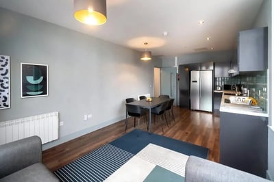 Modern living room with dining table kitchen exterior at Copley Court in Cork Student Accommodation