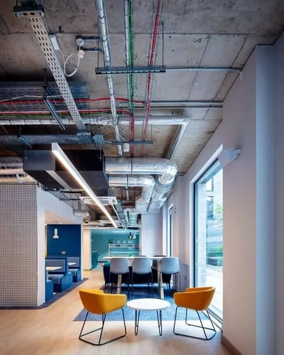 Orange chairs and tables communal area lounge at Coleman Court in Cork Student Accommodation
