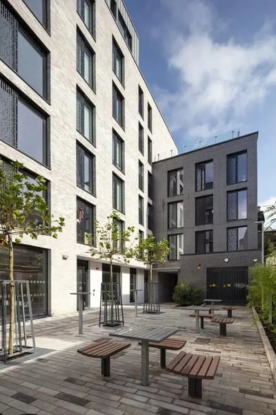 Picnic tables and trees in courtyard exterior at Coleman Court in Cork Student Accommodation