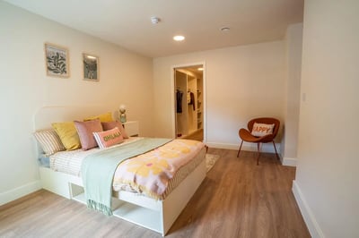 Bed closet chair artwork and pillows bedroom at Valerian in York Student Accommodation