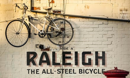 White bicycle on brick wall outside exterior at Nottingham Student Accommodation