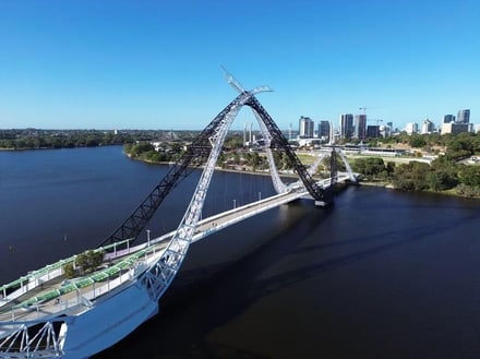 Modern bridge over dark water with city skyline exterior at Perth Student Accommodation