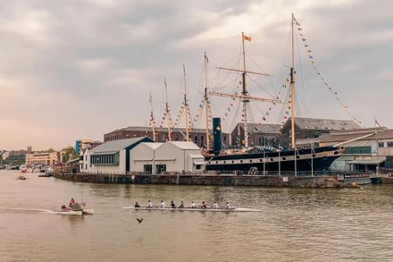 Ship at dock with rowers on river Exterior at Bristol Student Accommodation