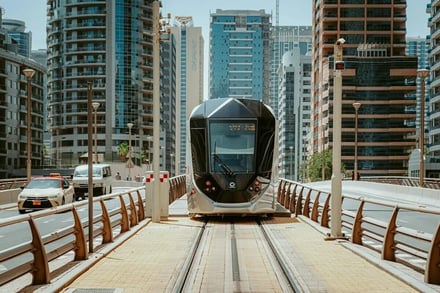 Tram on tracks with buildings exterior