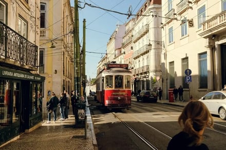 Tram on street with shops and people exterior